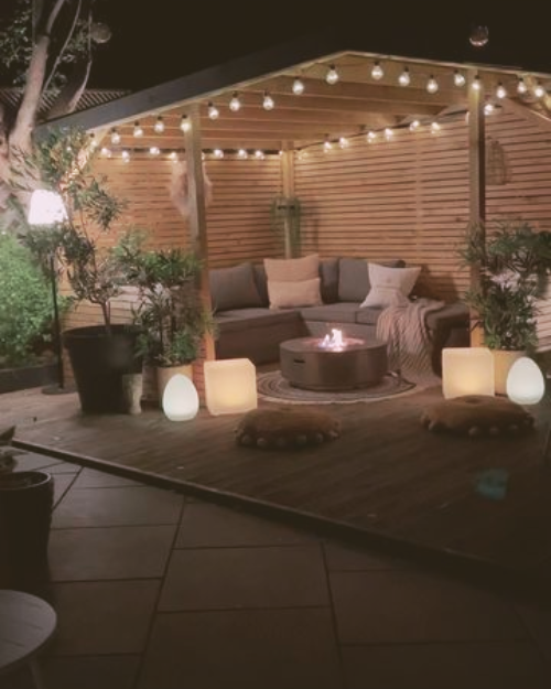 corner garden seating area with a firepit